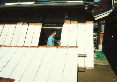 Mr. Fukunishi checks on paper drying in the sun